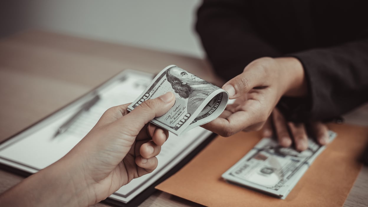 Man Handing out Salary to Employee